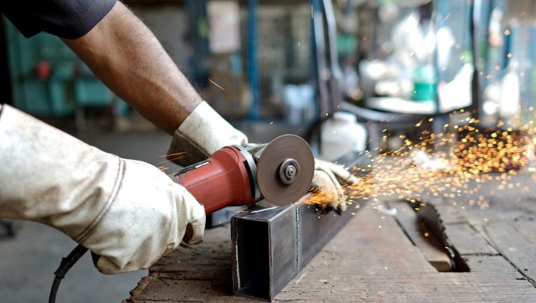 man cut metal with tool have spark light